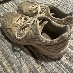 Asics cream and white tennis shoes.